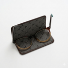 Pair of reading glasses on a flat glasses case